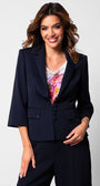 Woman wearing a tailored blazer fitted navy Alexa blazer with sharp lapel collar and five-button front closure over a floral blouse