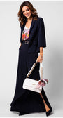 Woman wearing navy tailored blazer Alexa blazer with floral top and wide-leg trousers, holding white handbag with scarf detail