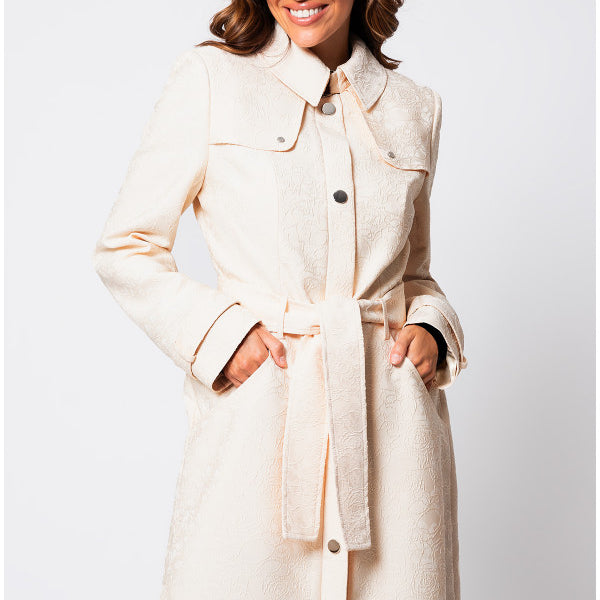 Front view of Rea Jacquard Trench Coat in Beige with waist belt and button closure. Luna Fashion House