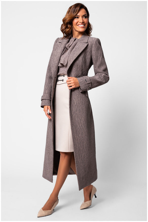Woman wearing a long gray coat over a white dress on a light gray background Luna Fashion House