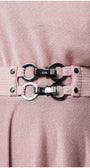 Close-up of a pink dress with a belt featuring silver buckles and black hardware. Luna Fashion House