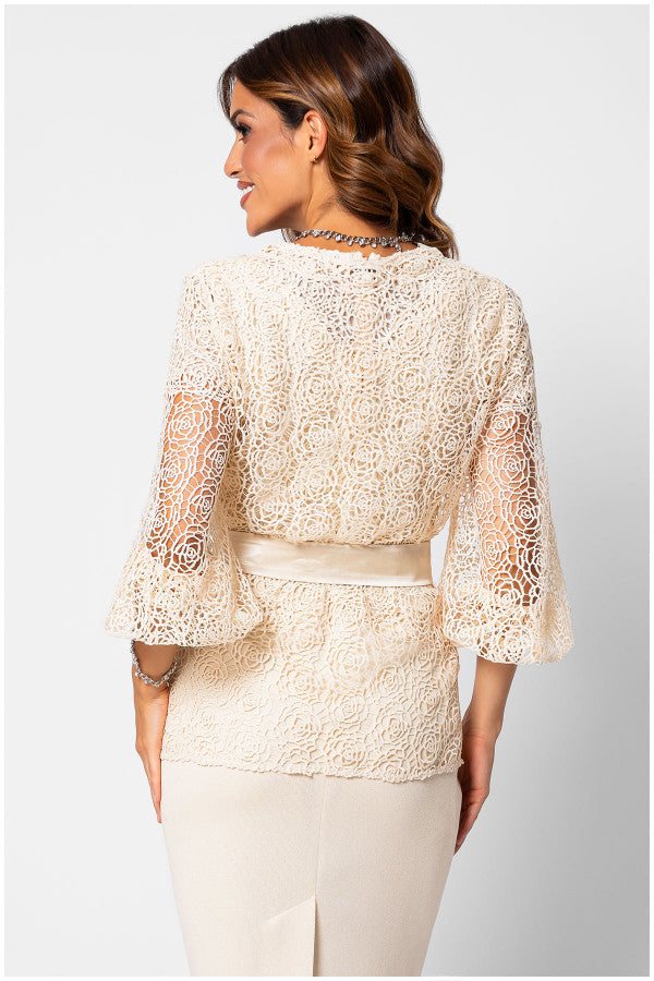 Back view of a woman ivory lace cardigan floral lace Sweater Jody with semi-sheer sleeves and a belted waist, styled with a light skirt.