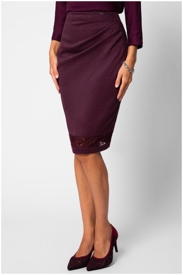 Woman wearing Bordeaux lace pencil skirt with draped waist and matching heels against plain background