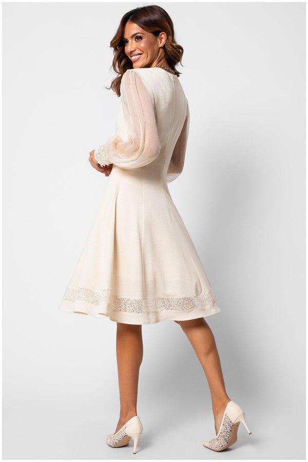 Woman wearing a white dress with sheer sleeves on a light gray background Luna Fashion House