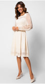Woman wearing a white dress with sheer sleeves on a white background Luna Fashion House