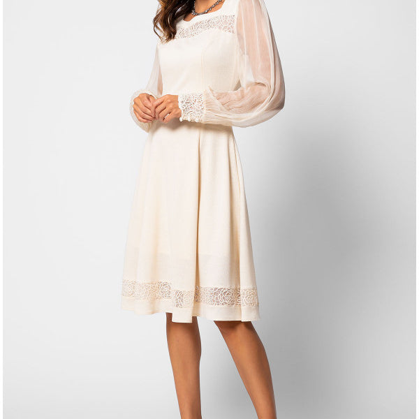 Woman wearing a white dress with sheer sleeves on a white background Luna Fashion House