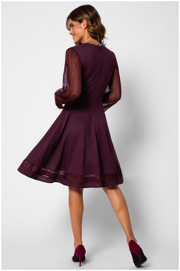 Woman wearing a burgundy dress with sheer sleeves on a white background Luna Fashion House