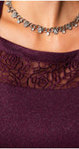 Close-up of a person wearing a purple garment with lace detailing and a silver necklace. Luna Fashion House