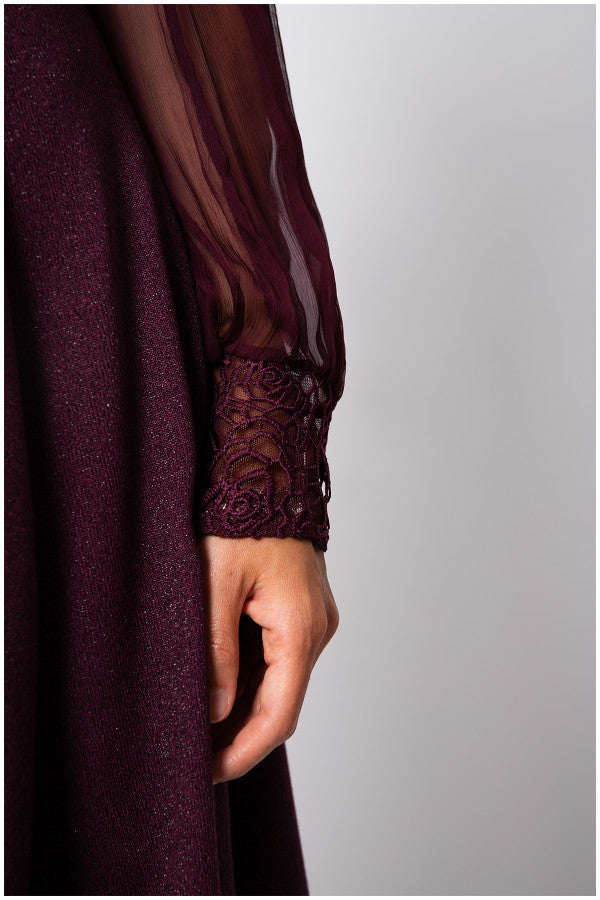 Close-up of a dark purple garment with lace cuffs on a plain background Luna Fashion House
