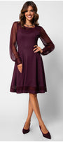 Woman wearing a burgundy dress with sheer sleeves on a white background Luna Fashion House
