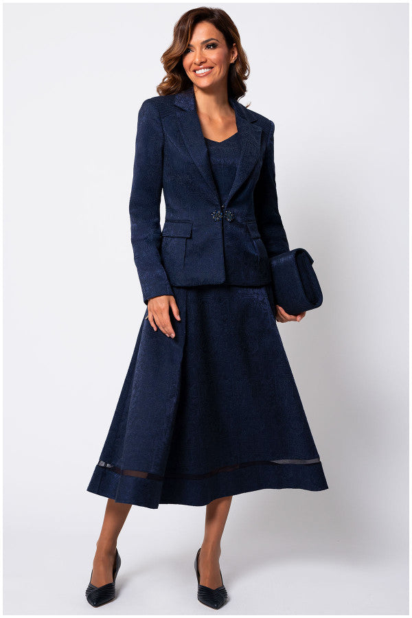 Woman wearing a navy blue suit with a white background Luna Fashion House