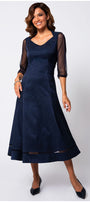 Woman wearing a navy blue dress with sheer sleeves on a white background Luna Fashion House