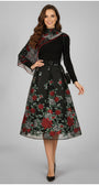 Woman wearing a black dress with floral patterns on a gray background