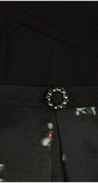 Black dress with floral patterns and a decorative belt featuring a circular design. Luna Fashion House