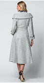 Woman wearing a gray coat with a belt on a white background