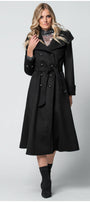 Woman wearing a black Luna Fashion House coat on a white background
