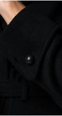 Close-up of a black Luna Fashion House coat with a button