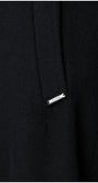 Close-up of a black Luna Fashion House coat with a brand label on a white background