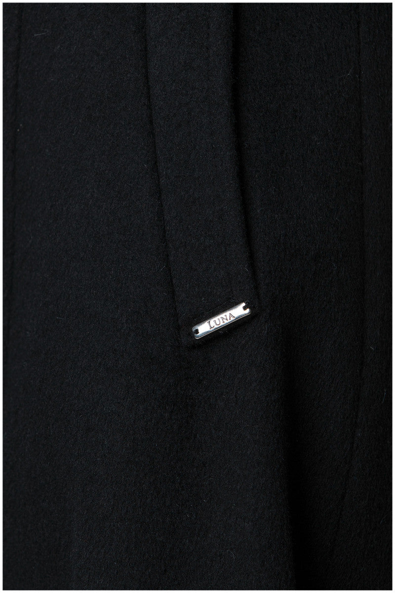 Close-up of a black Luna Fashion House coat with a brand label on a white background