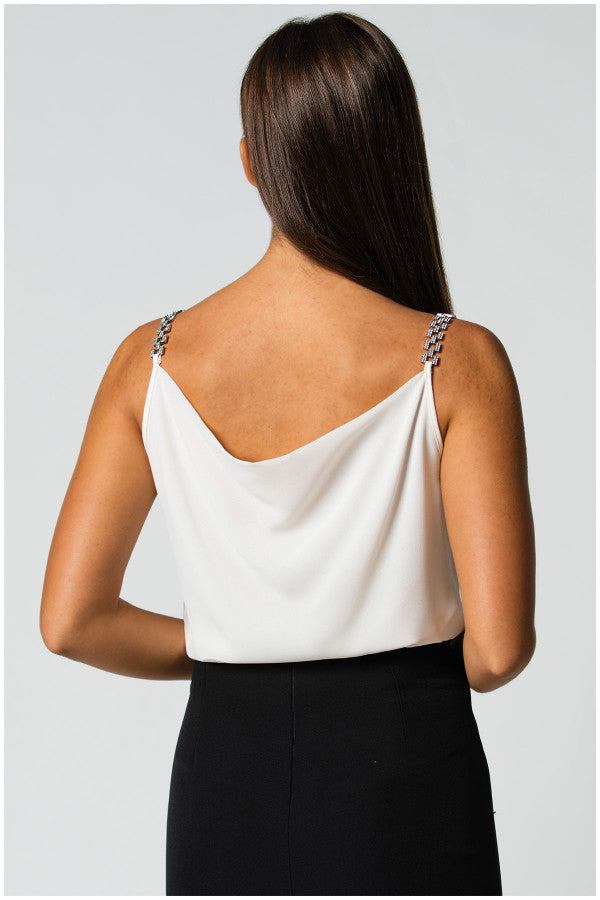 Back view of white elegant blouse Dora Blouse with jeweled straps and draped neckline worn with black skirt.
