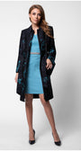 Woman wearing a black coat with floral patterns over a blue dress on a white background Luna Fashion House design