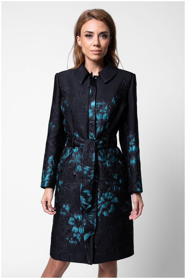 Woman wearing a black coat with blue floral patterns on a white background Luna Fashion House design