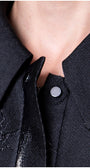 Close-up of a blackcoat with a button  Luna Fashion House design