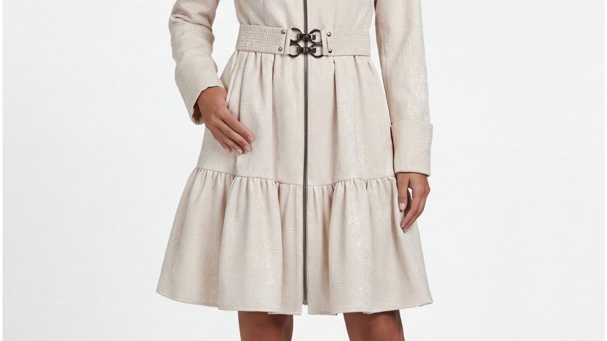 Beige cotton short tailored coat with belted waist and tiered hemline worn over a fall transitional outfit