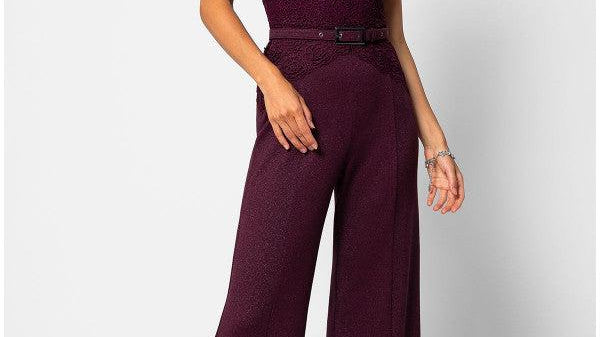 An elegant handmade lace jumpsuit in burgundy displayed against a soft neutral background, styled as a sophisticated wedding guest outfit