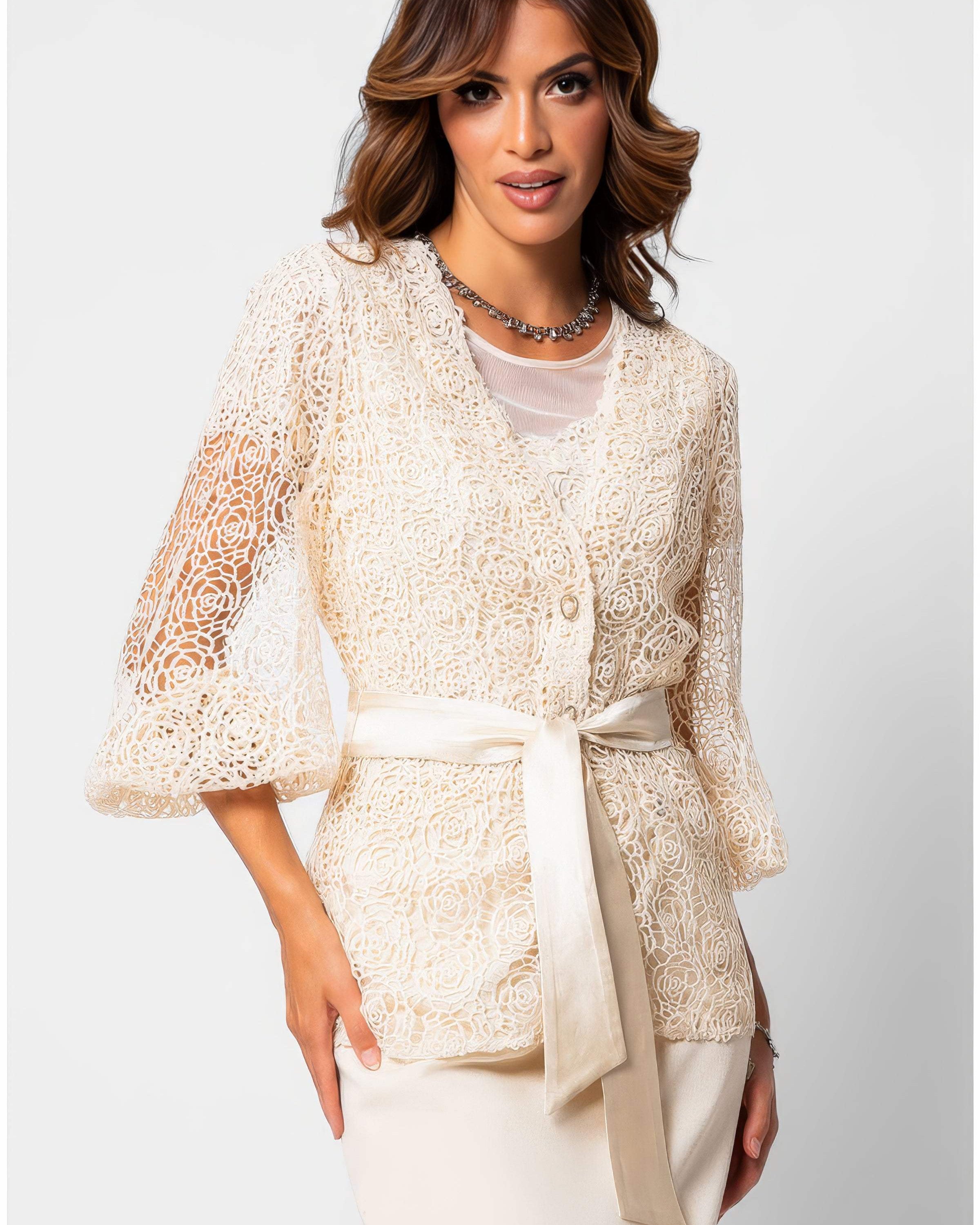 Ivory botanical fiber lace belted sweater with satin waist belt and draped silhouette on a white studio background