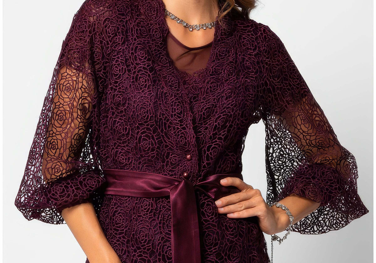 Black long-fiber wool coat with detachable faux fur collar on a woman in a formal winter arrival setting