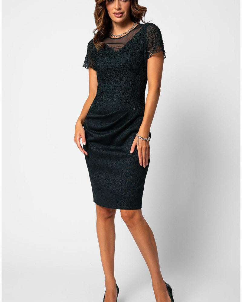 Midnight green lace midi dress with short lace sleeves and soft waist draping, worn as a fall mother of the bride look.