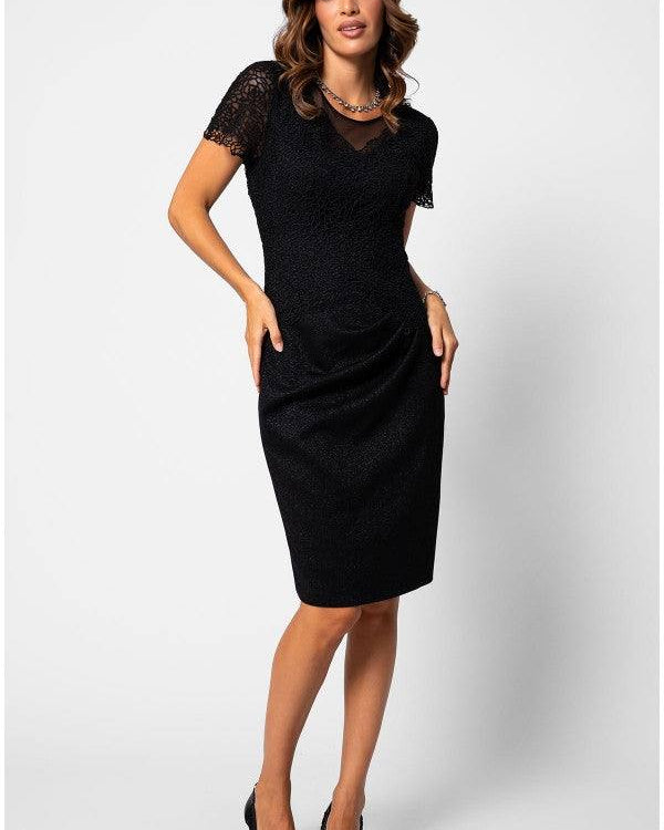 An elegant handmade black lace cocktail dress displayed against a neutral background, showcasing fine lace texture and tailored silhouette suitable for cocktail events