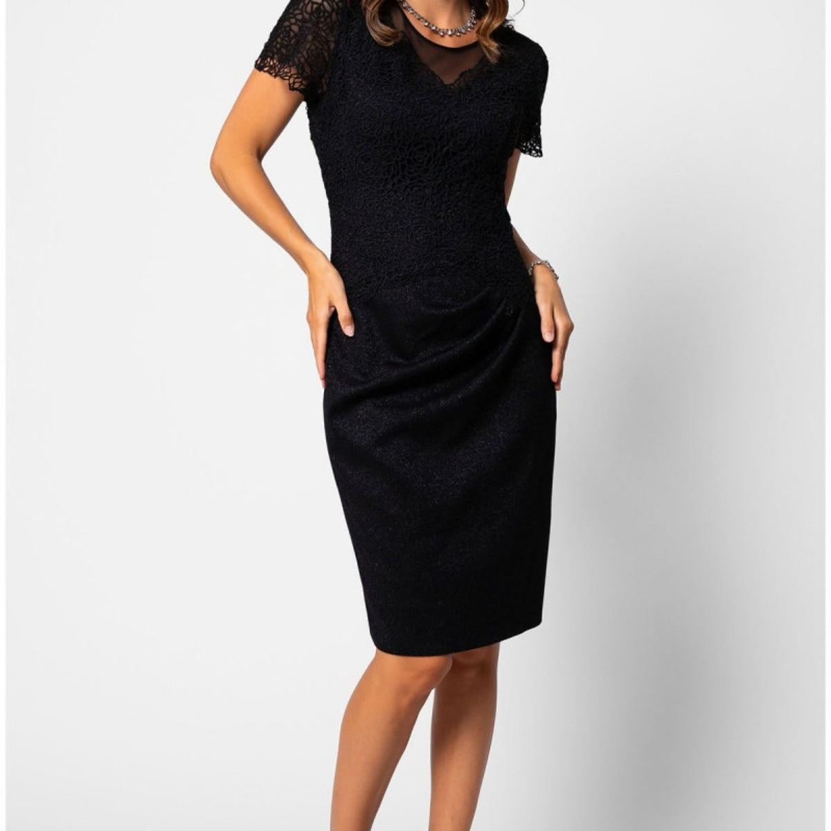 Black lace cocktail dress with sheer sleeves, shown for a guide to buying a dress online