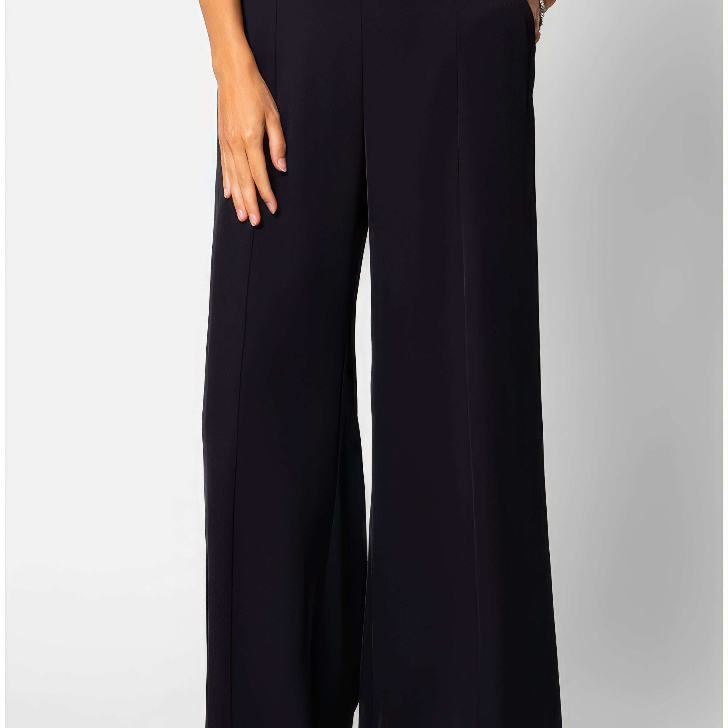 Black high-waisted wide-leg tailored trousers in fluid fabric with a clean natural waistline, front view on neutral background.