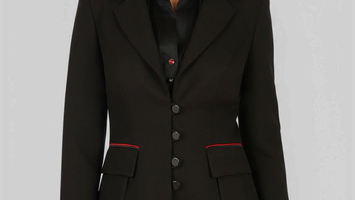 Black tailored blazer with self-tie belt in European cut worn over wide leg black trousers, photographed in a neutral studio setting.