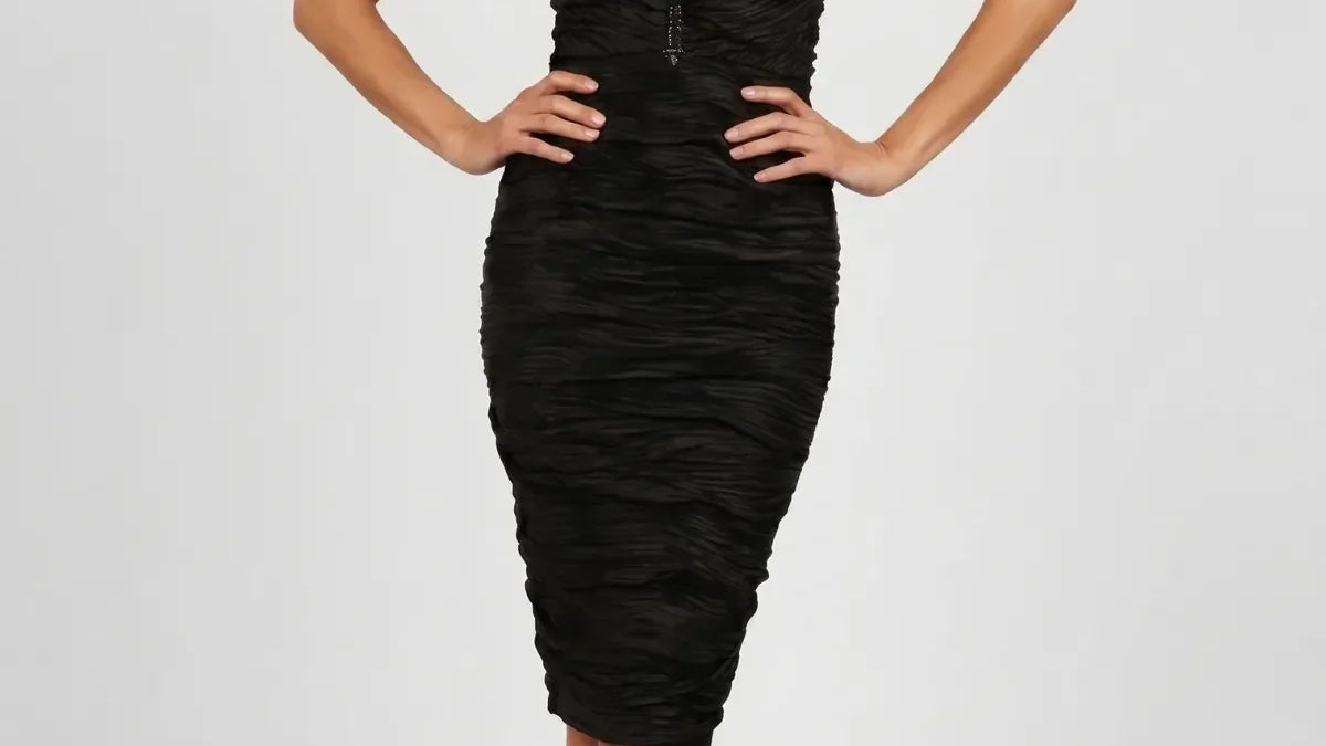 Fitted champagne gold off-shoulder pleated midi cocktail dress with pearl waist band on a woman at an evening event