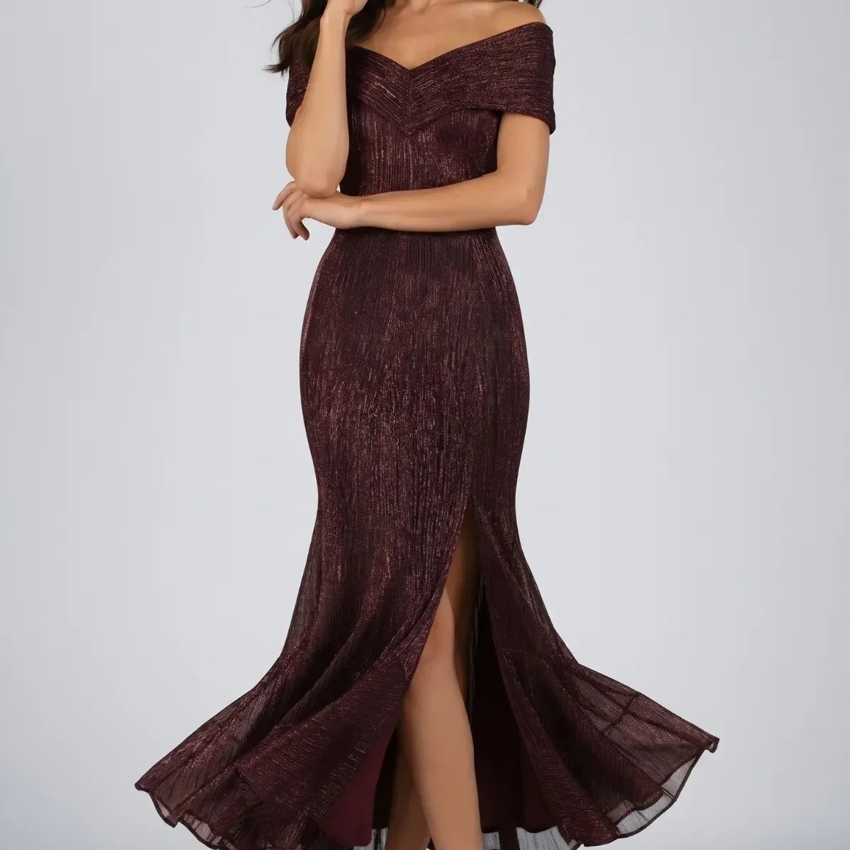 A selection of handmade Luna Fashion House eveningwear gowns including a burgundy metallic off-shoulder gown, a green and black sequin maxi dress, a champagne gold cocktail dress, and a black corset dress displayed in an elegant European atelier setting.