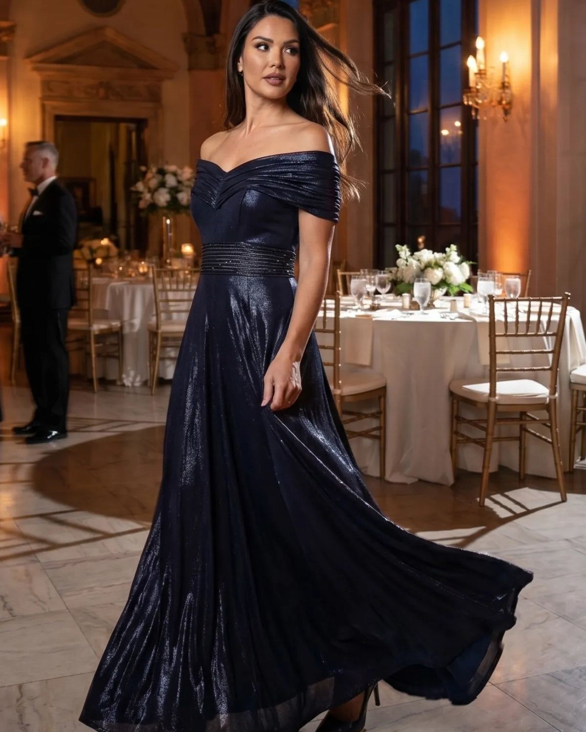 A woman wearing the Luna Iris Off Shoulder Maxi Gown In Navy