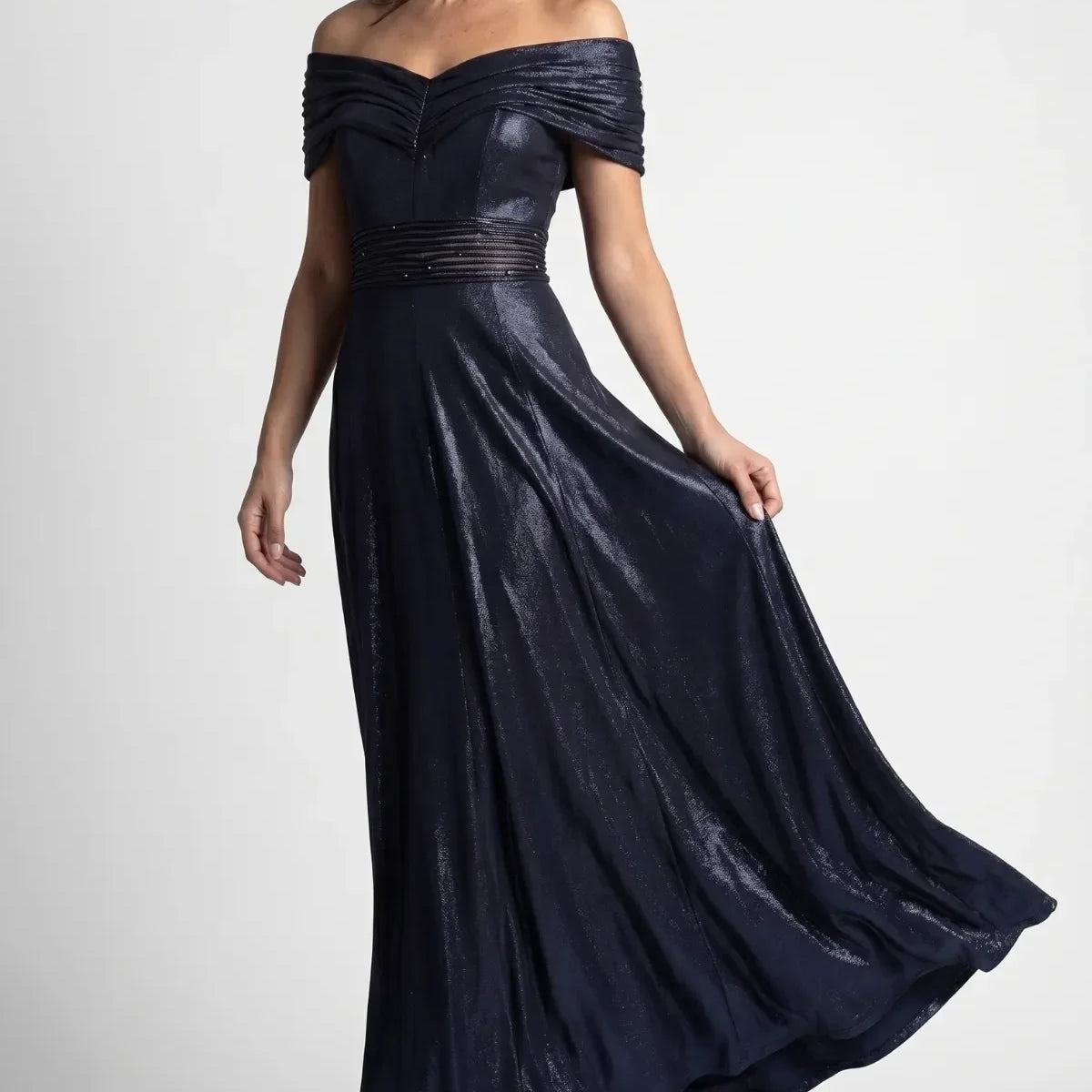 Full length navy off-shoulder maxi gown with metallic sheen, beaded waist, and flowing skirt for black tie occasions