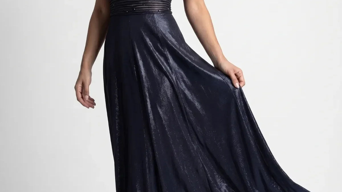 Full length navy off-shoulder maxi gown with metallic sheen, beaded waist, and flowing skirt for black tie occasions