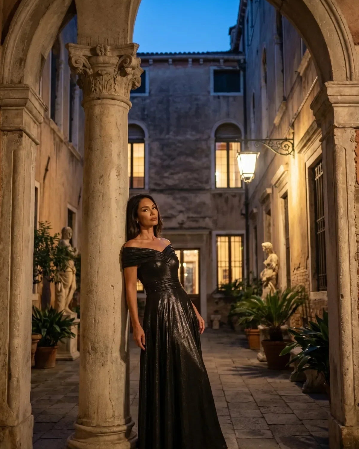 A woman wearing the Luna Iris Off Shoulder Maxi Gown In Anthracite