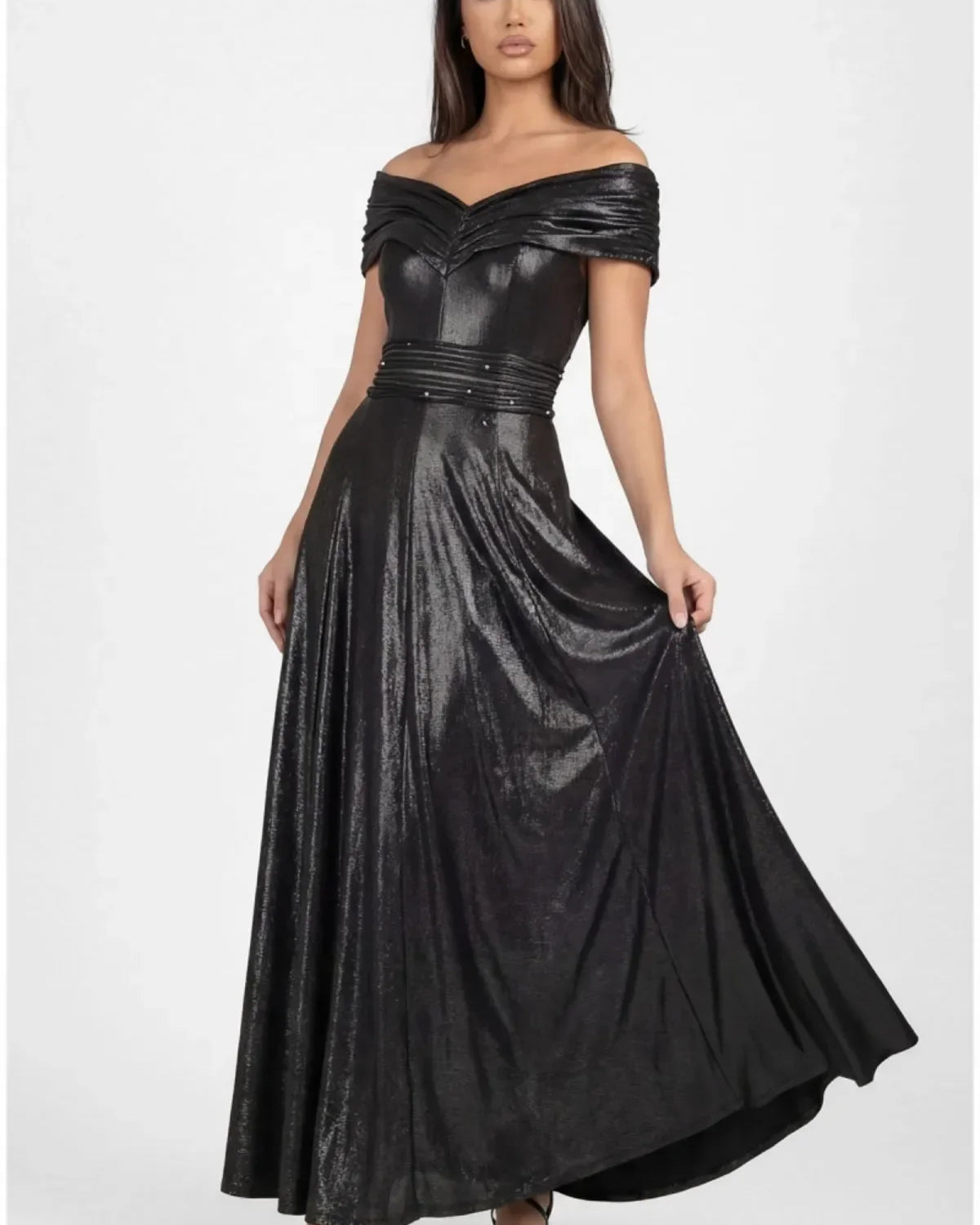 Floor-length anthracite metallic off-shoulder maxi gown with crystal-set waistband and flowing skirt on a tall figure