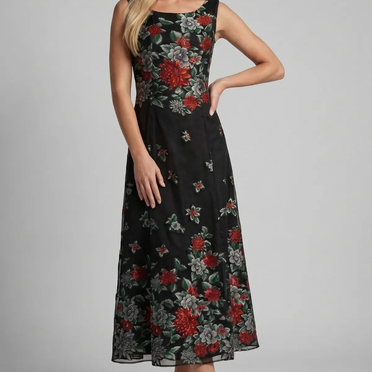 Black embroidered floral maxi dress with red and gray blooms on sheer ground, sleeveless with gathered bodice and flared skirt