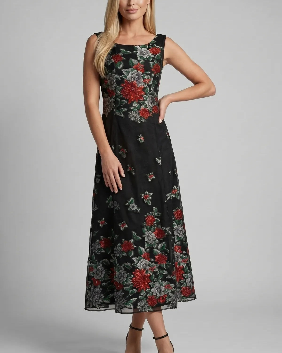 Black embroidered floral maxi dress with red and gray blooms on sheer ground, sleeveless with gathered bodice and flared skirt