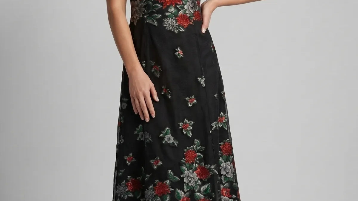 Black embroidered floral maxi dress with red and gray blooms on sheer ground, sleeveless with gathered bodice and flared skirt