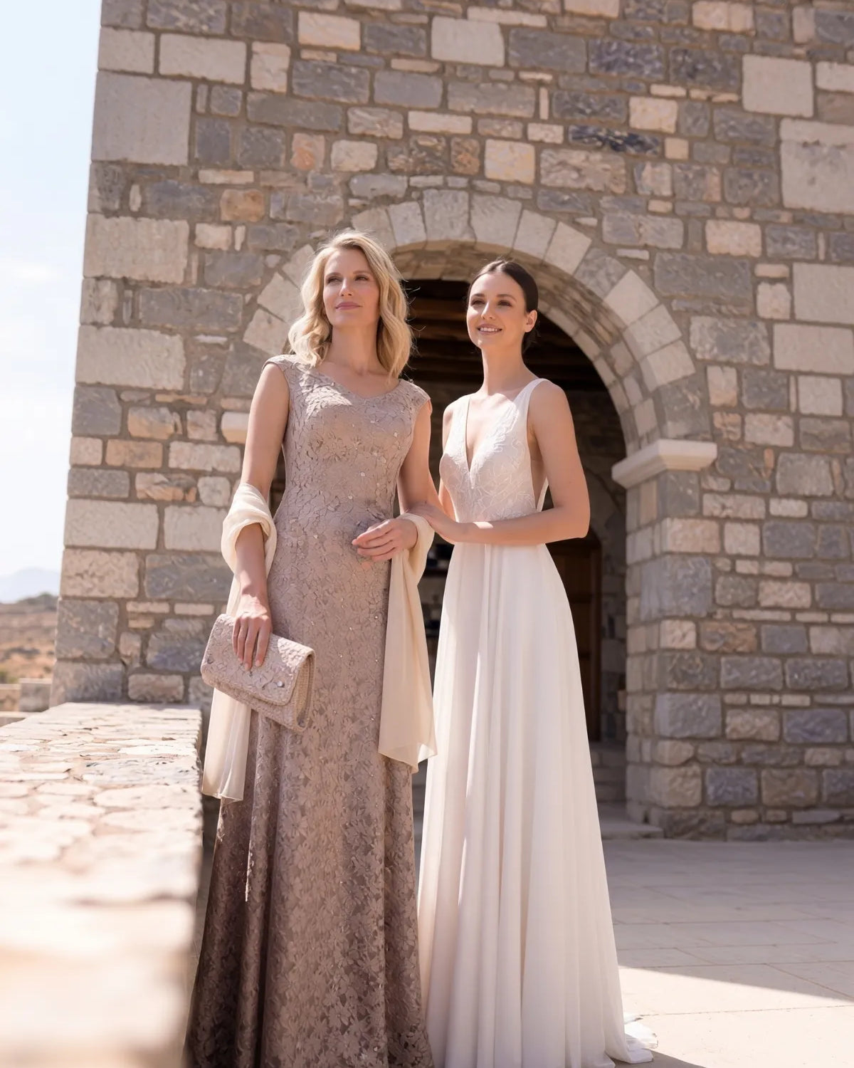 Mother of the bride dress options in ivory and jewel tones on display