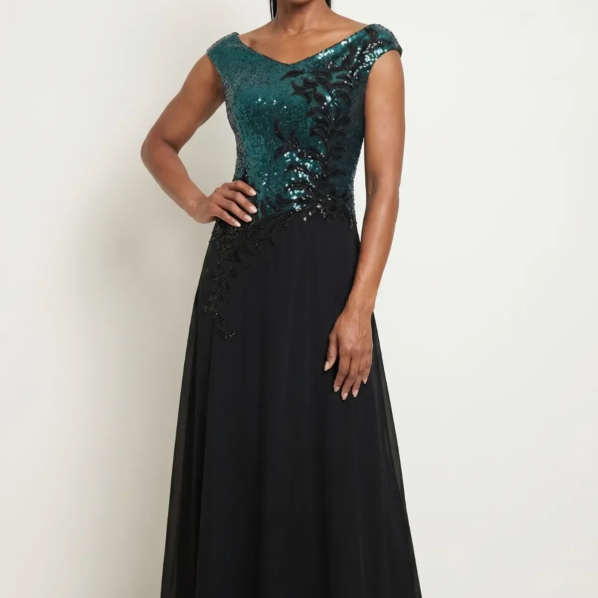 Floor-length evening gown with teal sequined bodice graduating from turquoise to forest green above a flowing black chiffon skirt