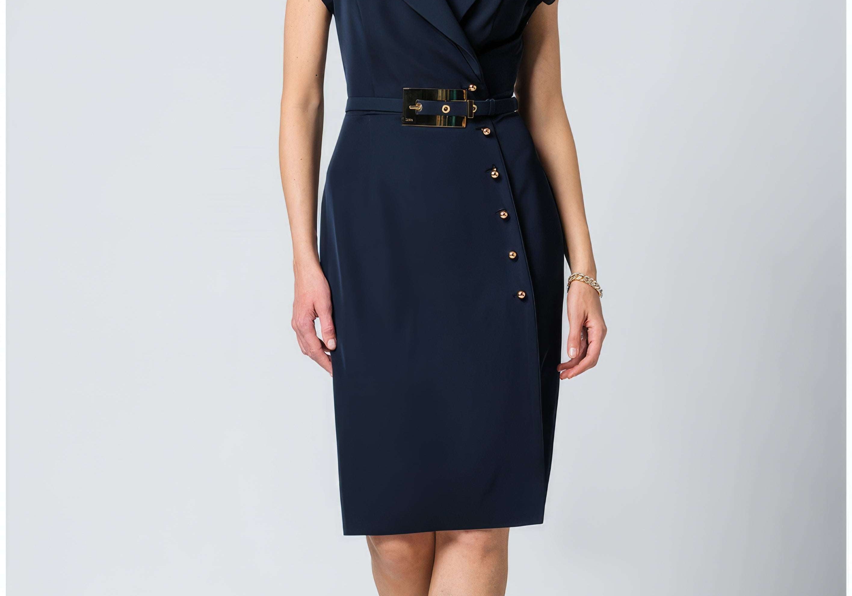 Navy wrap dress with a notched collar, short sleeves, gold buckle belt, buttons down the wrapped skirt, knee length