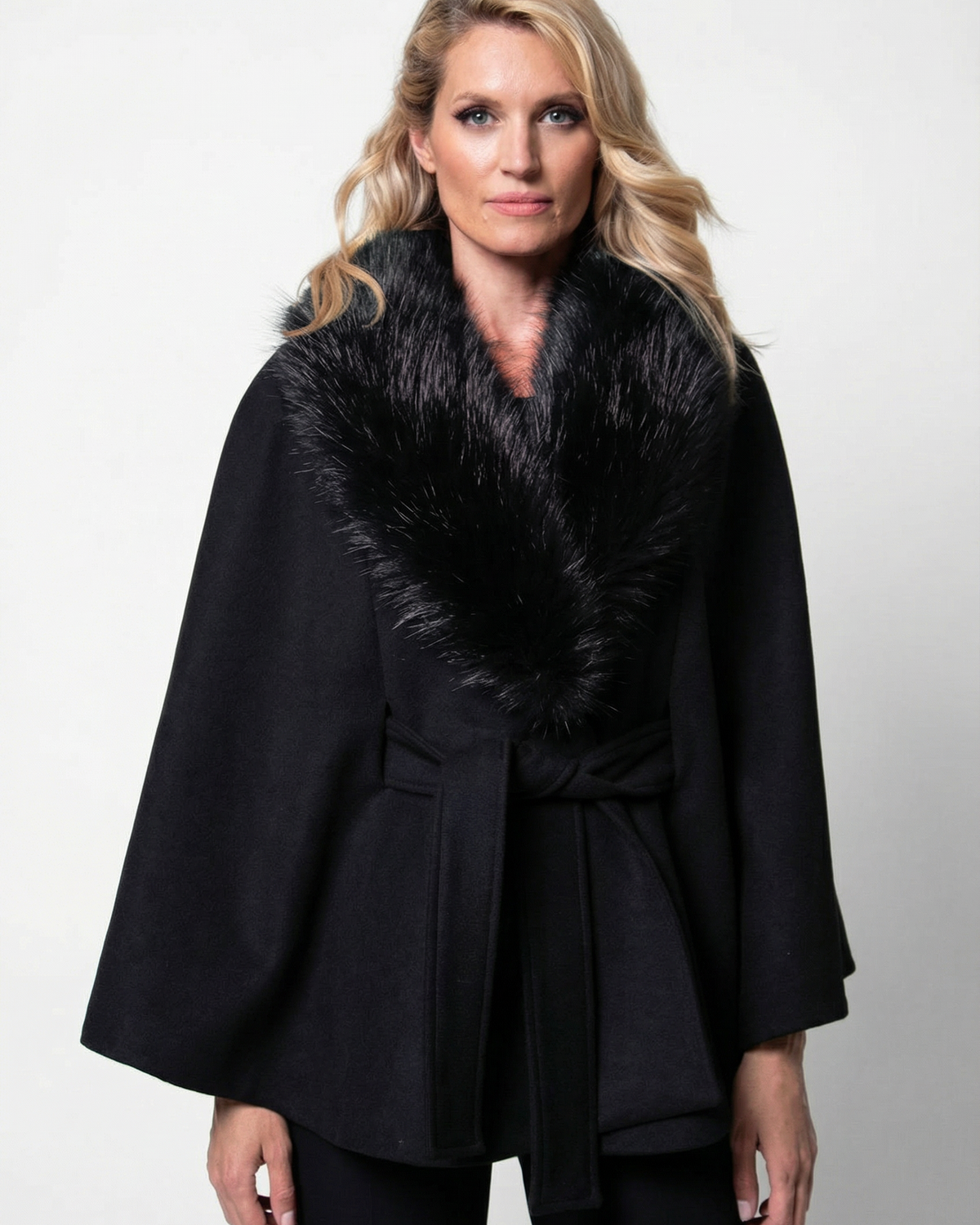 Black wool cape worn over an evening gown for a cold-weather formal event